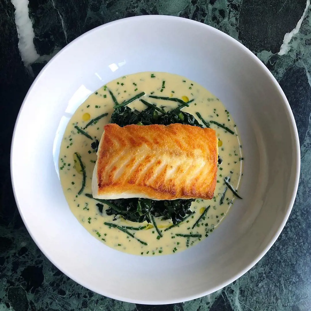 Pan fried Hake Fillet & Veloute with Chives Sautéd Cavolo Nero & Samphire