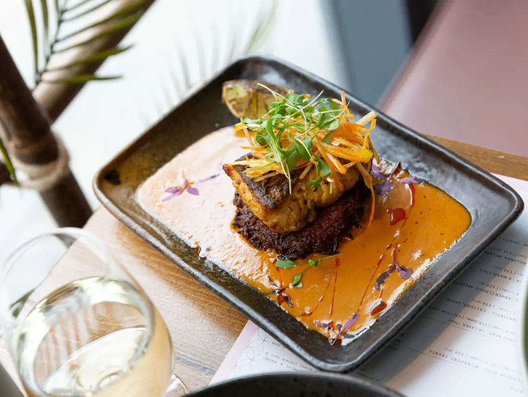 Hake Masala with lemongrass & cassava rosti and charred lime on top of a rich and fragrant Masala sauce