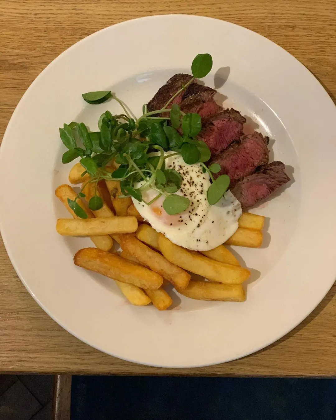 Grilled 8oz Bavette Steak served with a Fried Egg, Triple Cooked Chips and Watercress