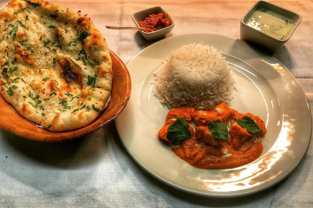 Butter Chicken served with Rice, Naan, Chutney and Mango Pickle