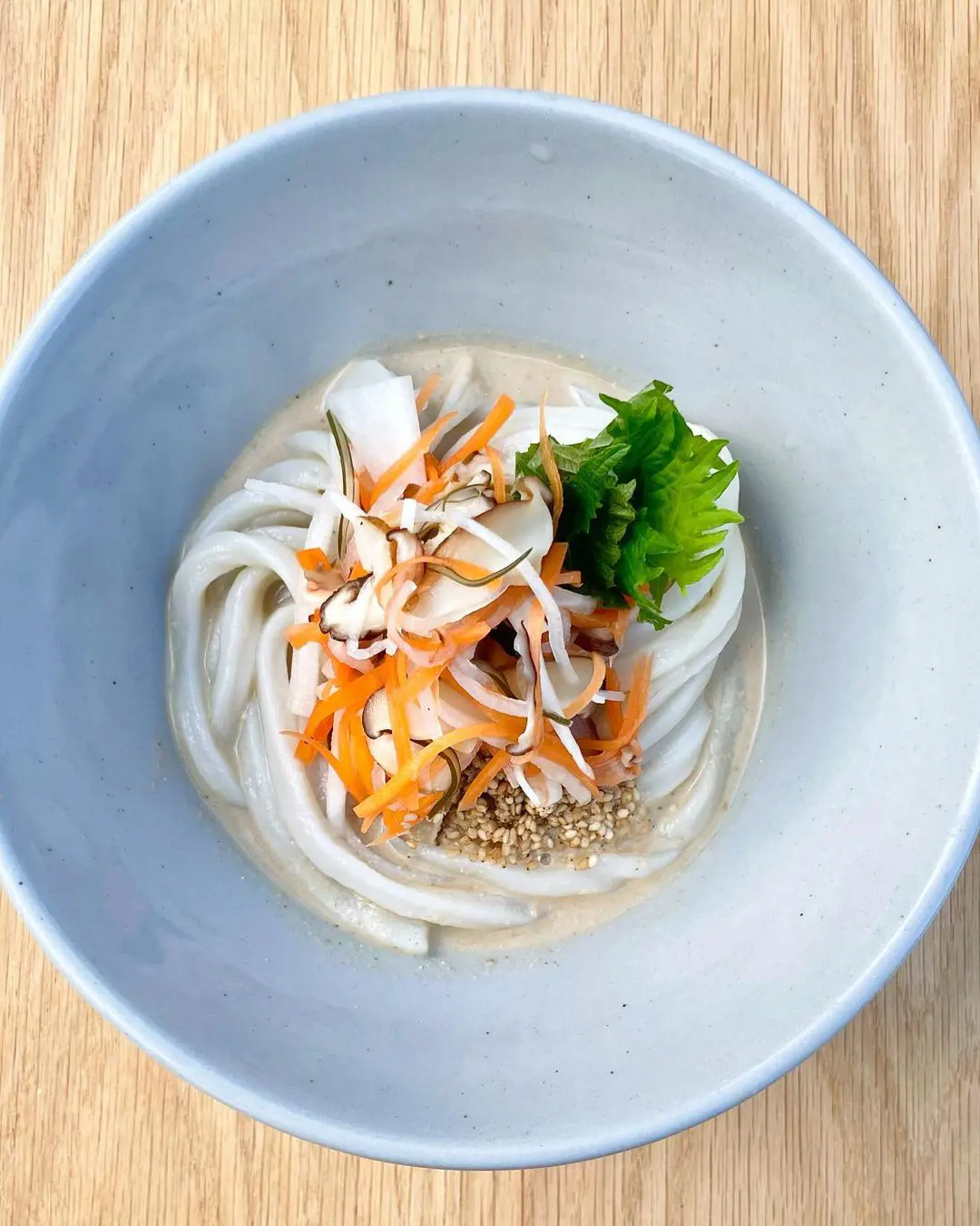 Sesame sauce udon(chilled) with pickled Daikon, carrot, shiitake and shiso.