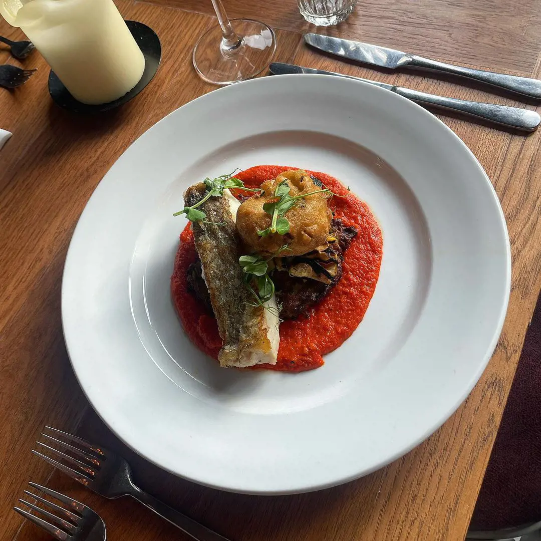 Cod fillet, courgette cake, romesco sauce and crab beignet