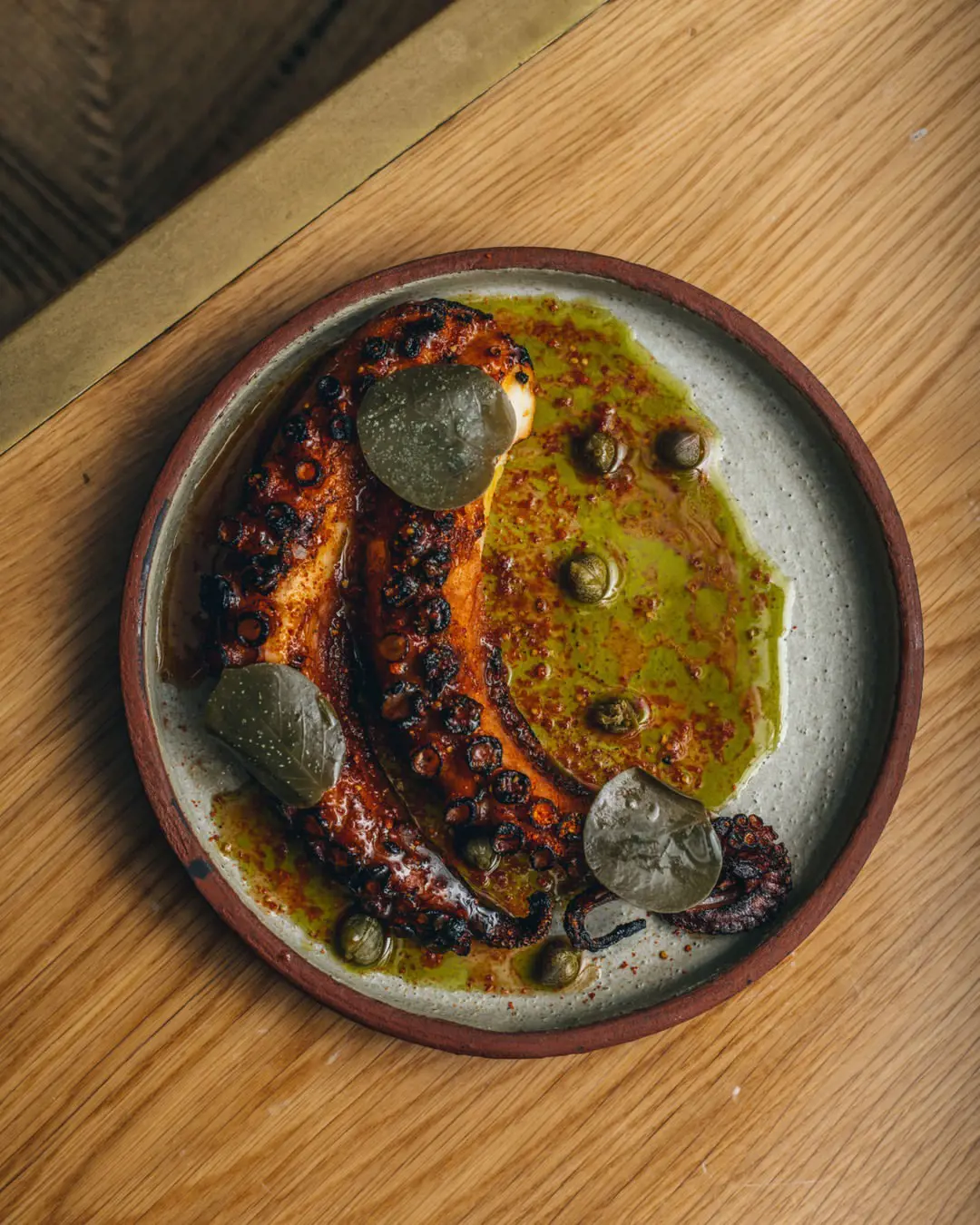 Octopus with olive oil, sherry vinegar, caper leaves.