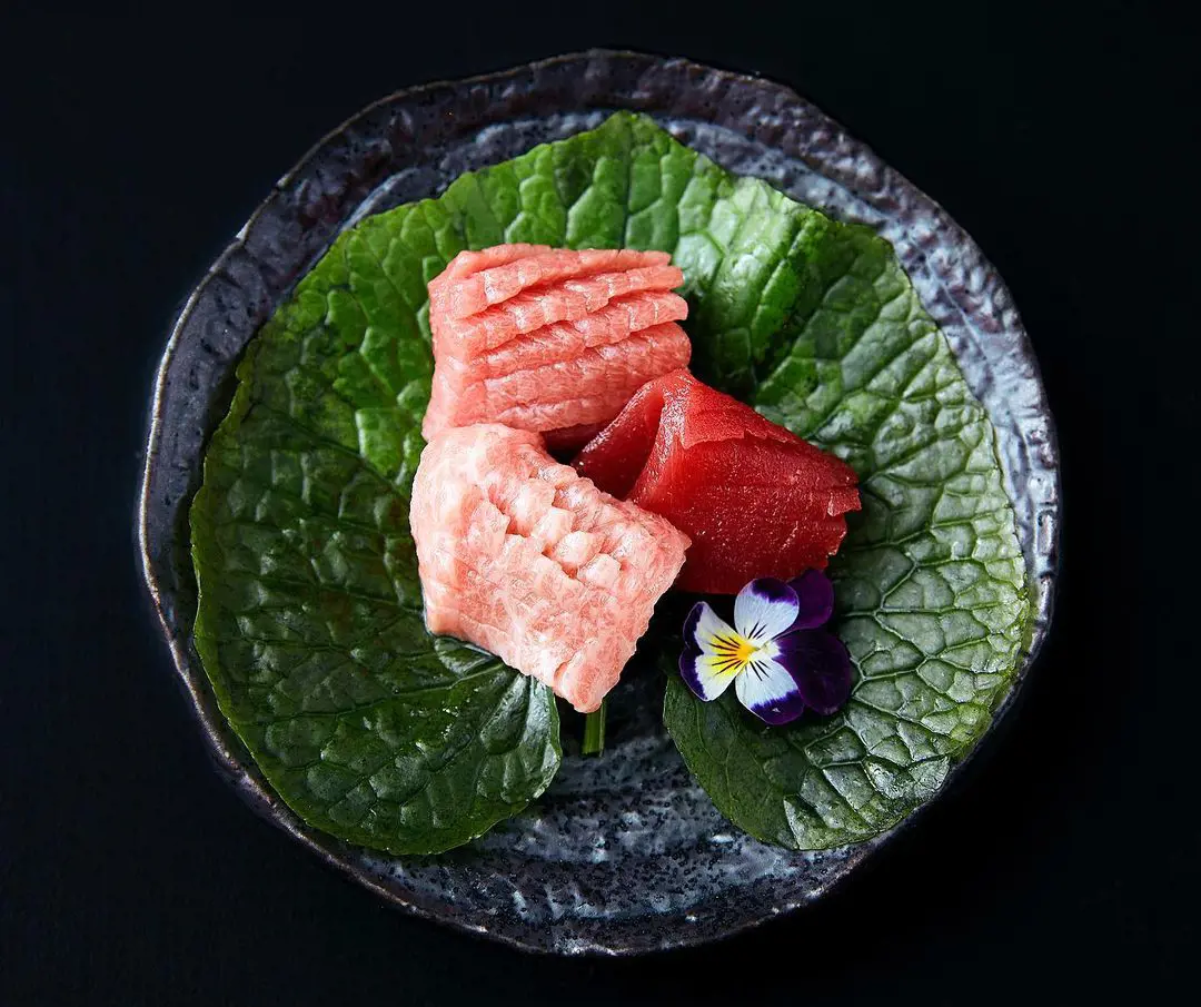 fresh tuna sashimi on a wasabi leaf