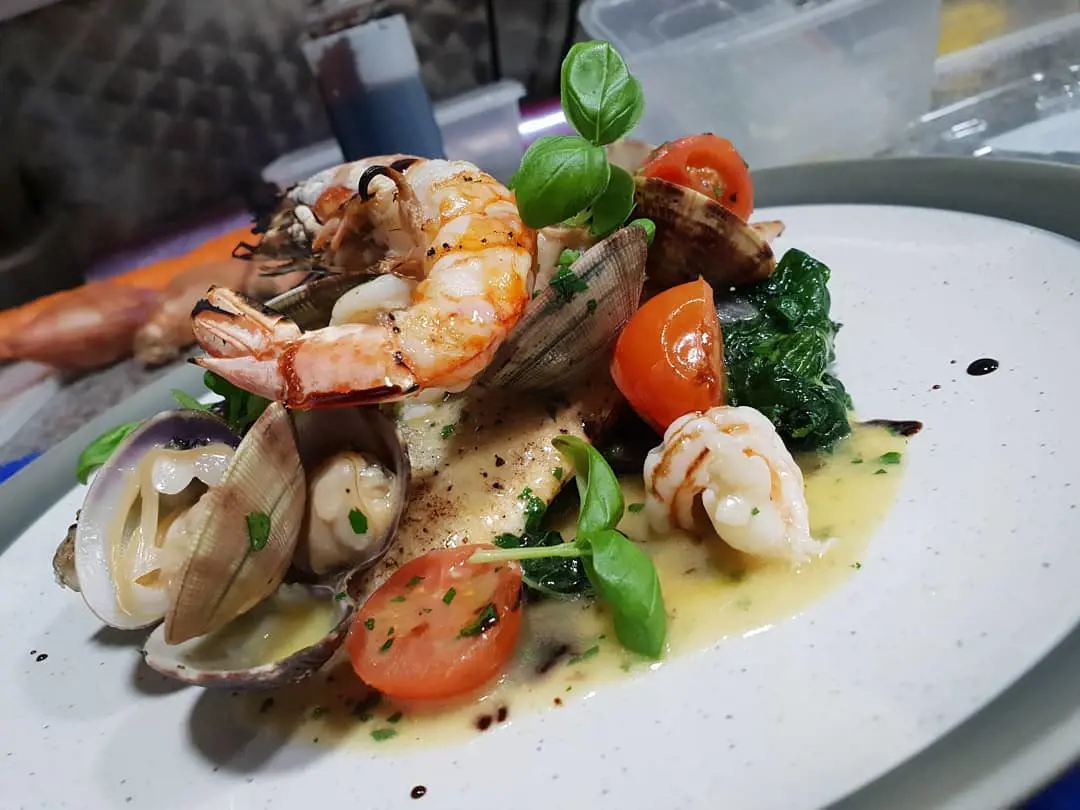 Sea bass fillet, prawns, clams and greens