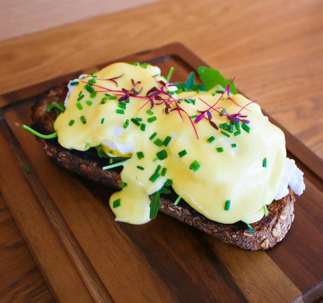 Eggs benedict on toast topped with Hollandaise sauce