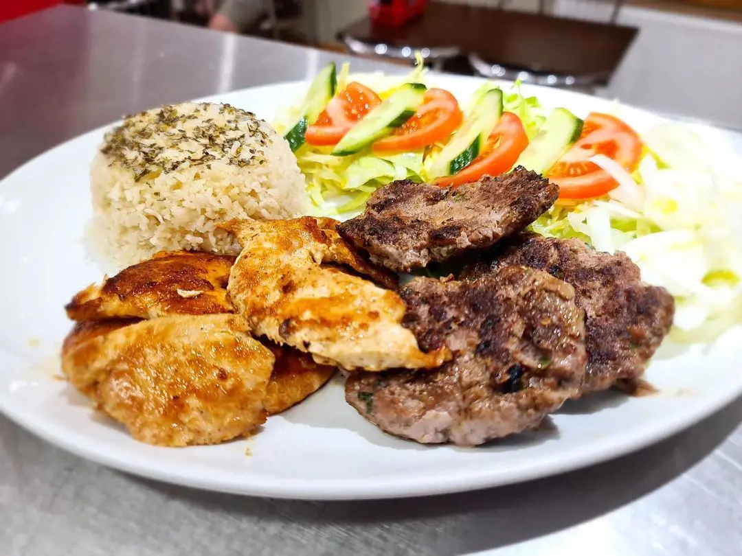 Half grilled chicken and half Kofte served with rice and salad