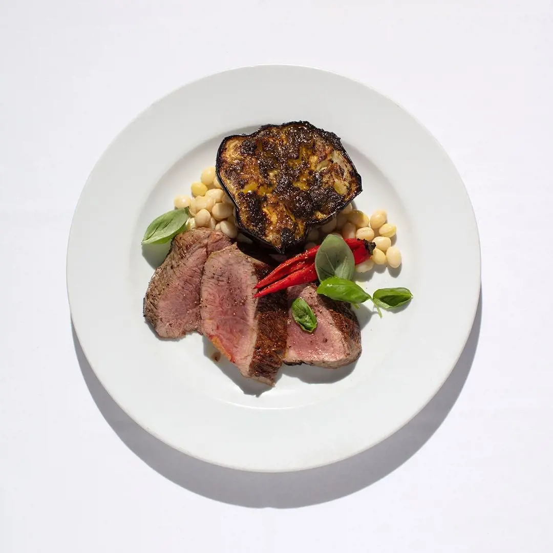 Leg of lamb with grilled red chillies, wood-roasted aubergine and cannellini beans