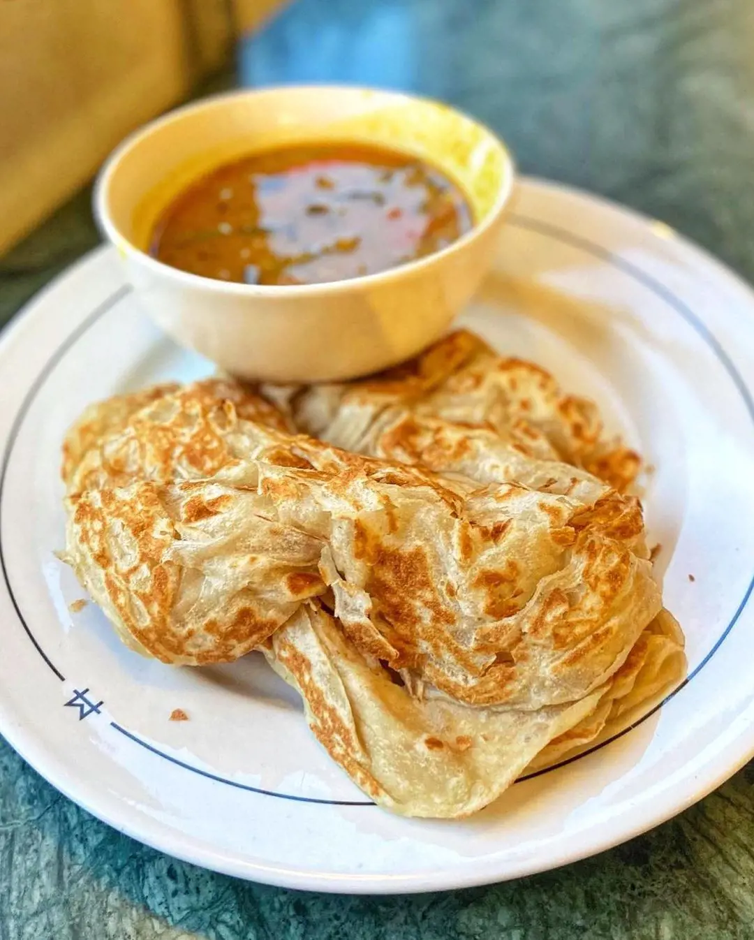 Roti canai served with “Sambar”, a lentil and veg stew.
