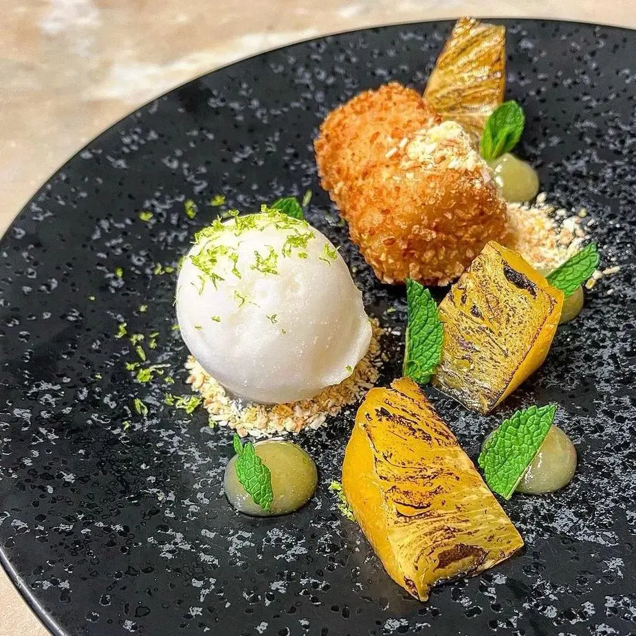 deep fried rice pudding with coconut, kaffir lime sorbet, rum, roast pineapple and mint