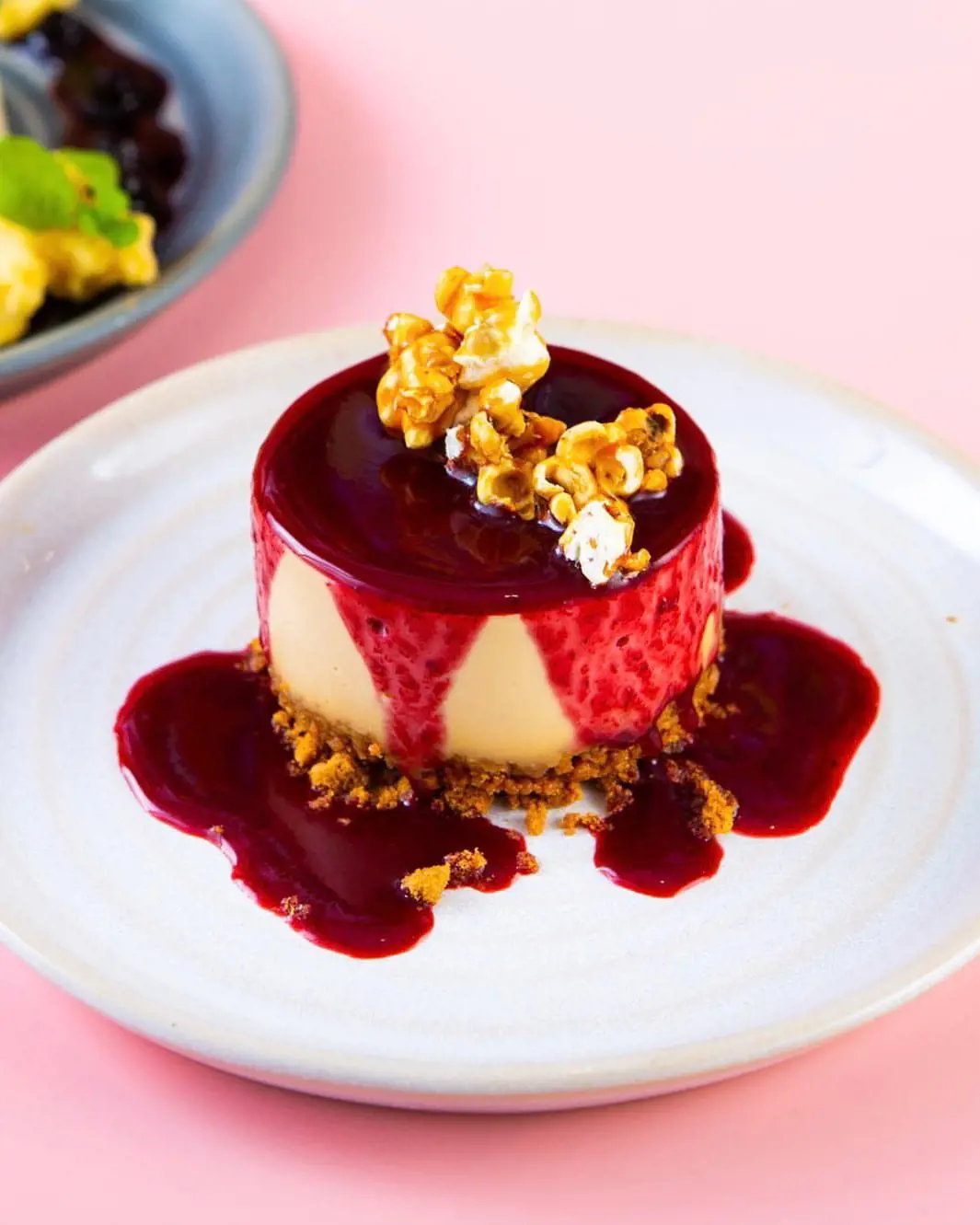 caramel cookie cheesecake with blackberry coulis