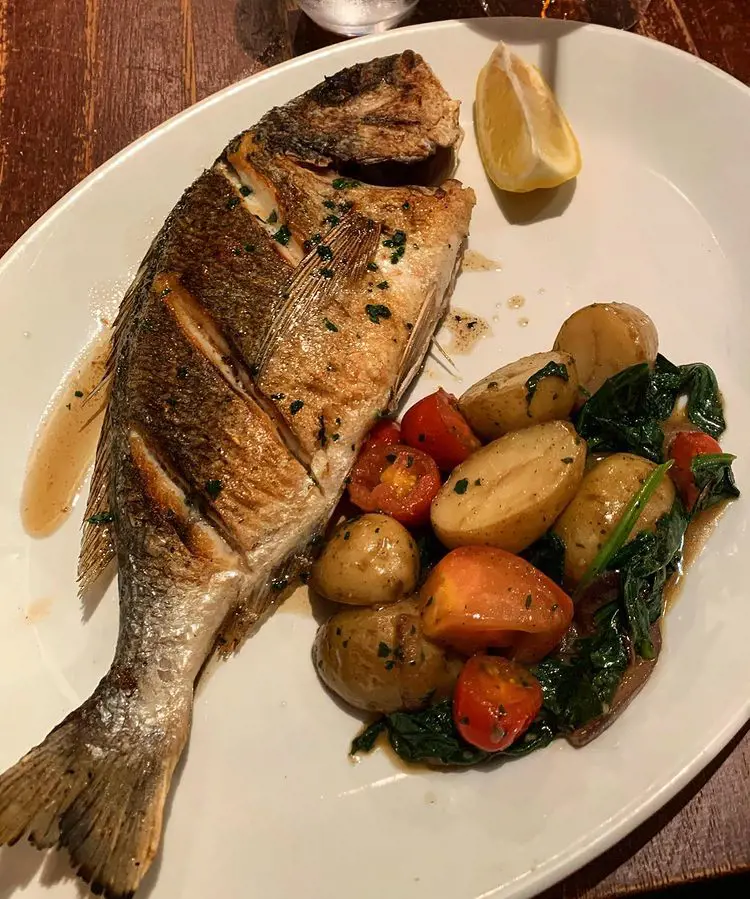 Sea bream fish, served with roast potatoes and spinach