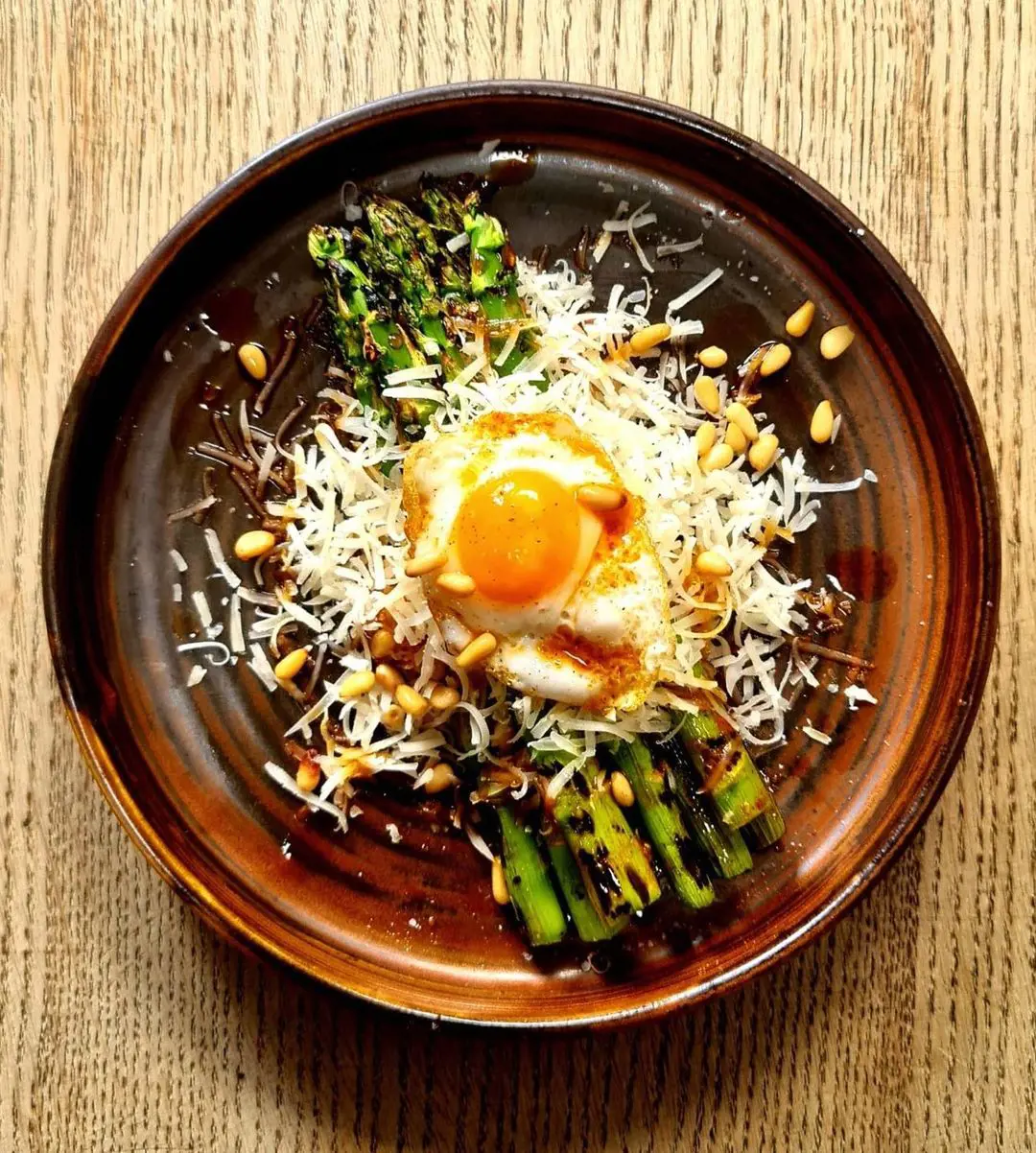 Grilled asparagus, manchego cheese, quail eggs, toasted pine nuts, paprika oil