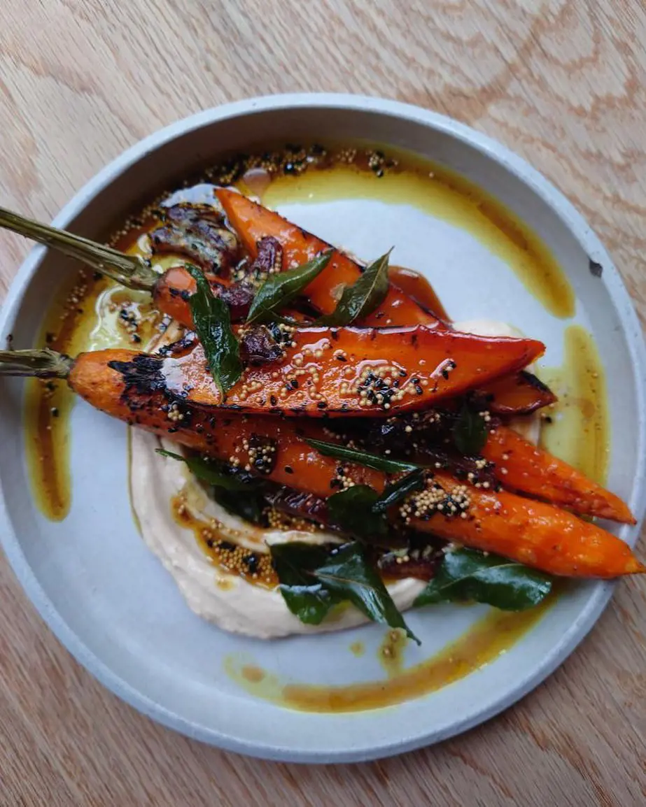 Roasted carrots, tamarind yoghurt with a date & hawaij butter and curry leaf