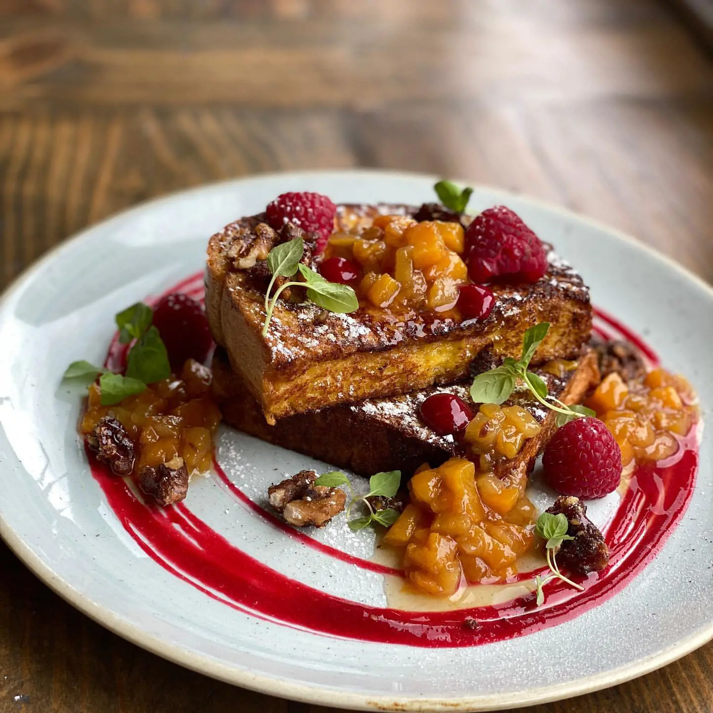 Brioche French Toast with Peach Compote, Raspberry Coulis and Candied Walnuts